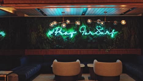 unique sitting lounge area of hotel with neon sign