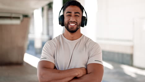 face, fitness and music with a man arms crossed