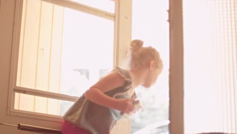 a little girl holds open a screen door and her dog accidentally gets out