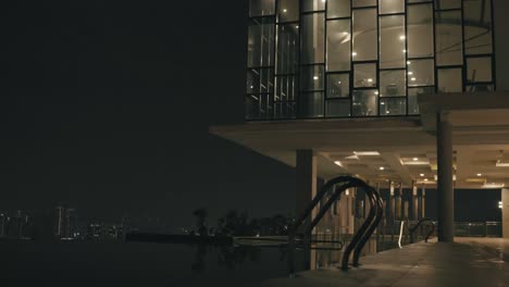 view of empty swimming pool in luxury resort with cityscape at background in kuala lumpur, malaysia.