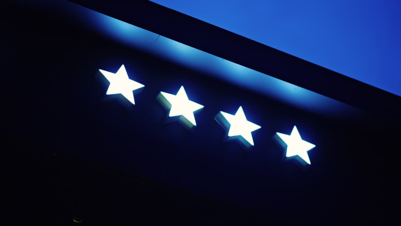 White neon 4 star hotel sign on black background