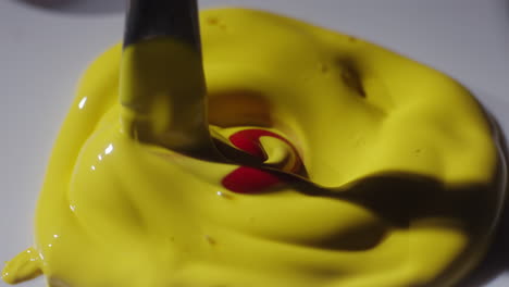 mixing yellow paint with red and orange