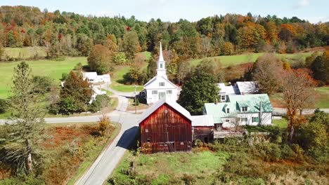 an aerial over a charming small village scene in vermont with church road and farm 1