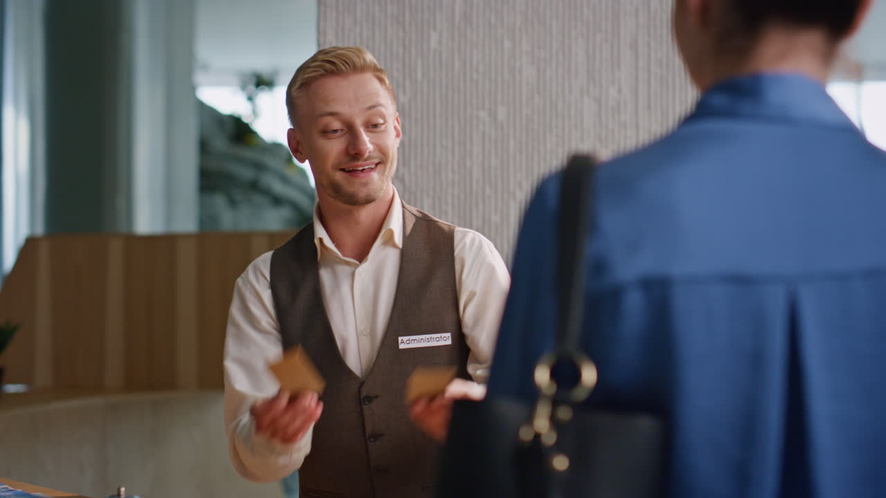 Hotel concierge assisting clients on arrival closeup. Smiling professional work