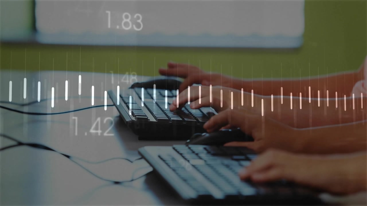 Two classmates typing keyboards and activating education tech overlay with pulsing line graph
