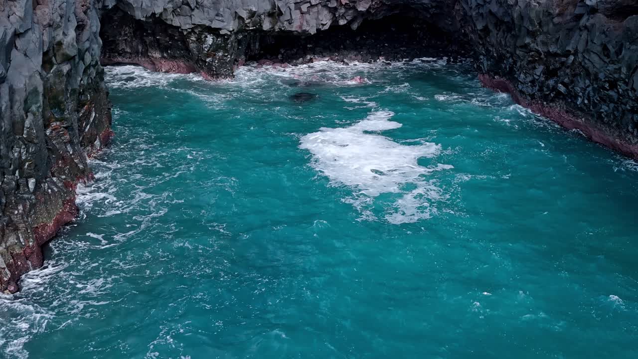 Powerful ocean waves crash violently into the volcanic cliffs of Los Hervideros in Lanzarote, Canary Islands, Spain.