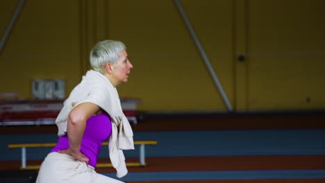 senior woman warming up indoors