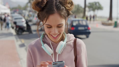 portrait of cute young hispanic woman using smartphone texting browsing online enjoying sharing summer vacation experience messaging social media on busy beachfront