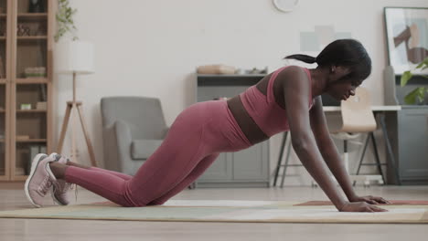sporty african-american woman doing push ups
