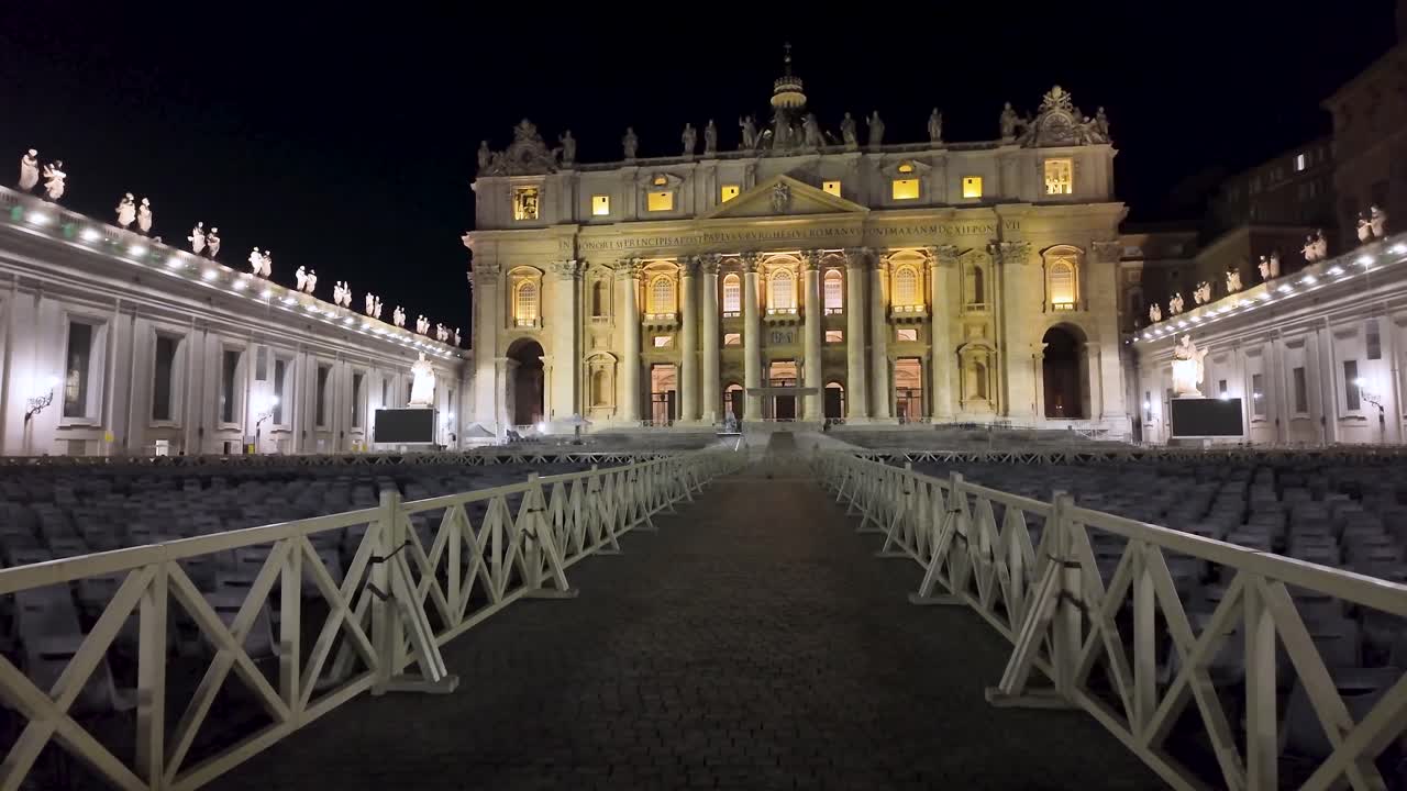 Nighttime ascending shot of the main façade of the basilica and St. Peter's Square in Vatican City