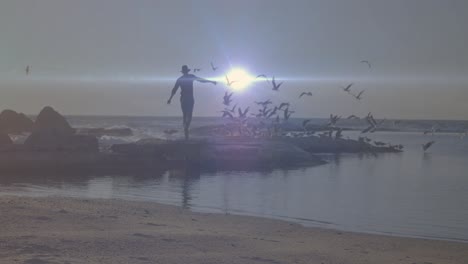 바다 근처의 바위에서 즐기는 아프리카계 미국인에 대한 밝은 빛의 반점