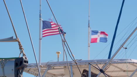 flag of the united states and the dominican republic waving on motorboat