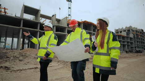 team of architect foreman and builder is walking on construction site building inspection