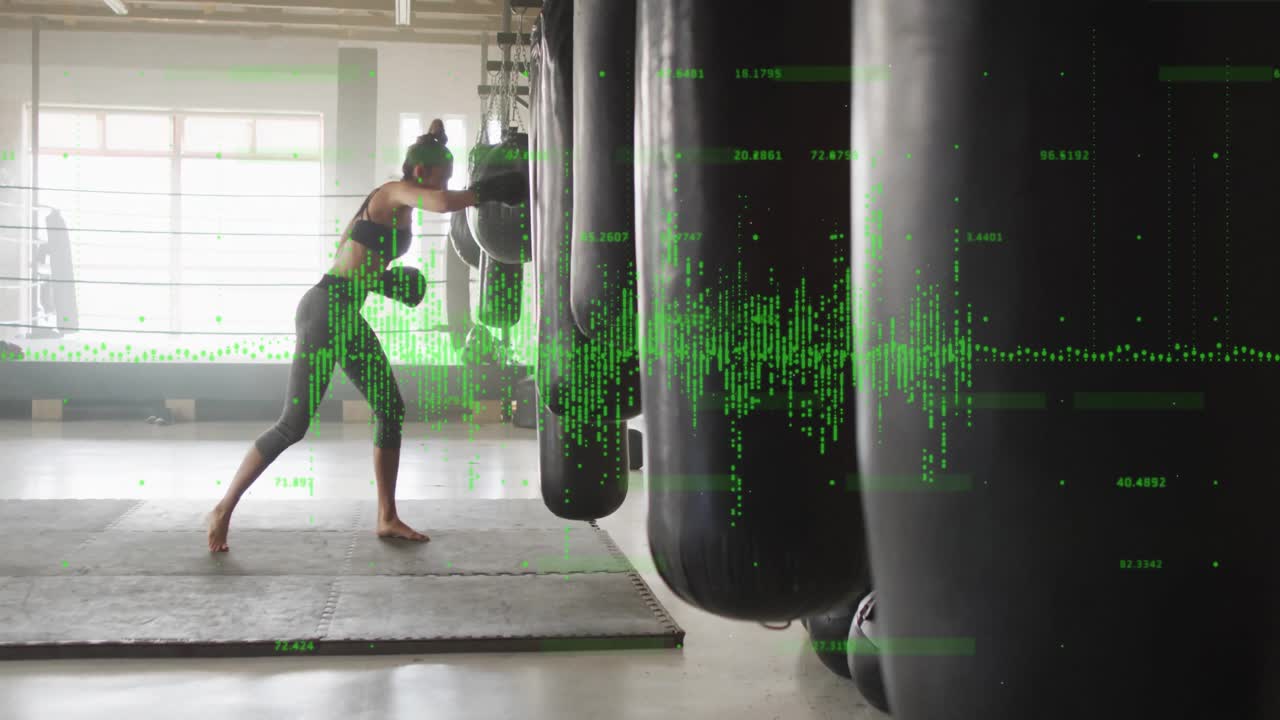 Boxer training with punching bag, green data visualization animation over gym scene