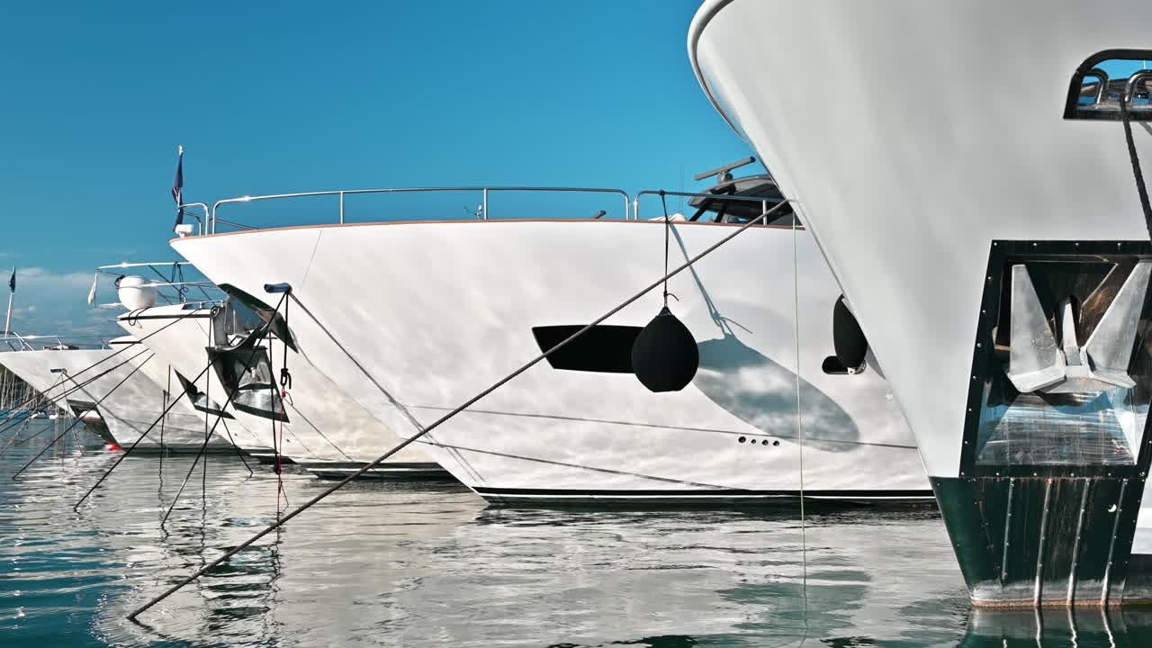 View of the sea port of Antibes, France. Moored yachts, blue water of the Mediterranean sea
