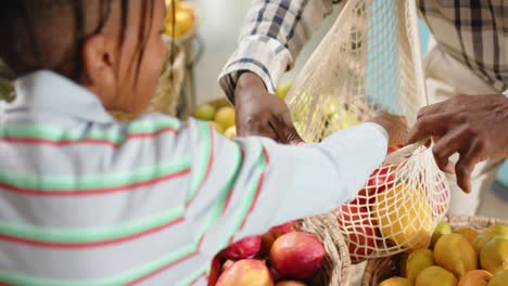 feliz anciano abuelo afroamericano y nieto de compras en una tienda de alimentos saludables, cámara lenta