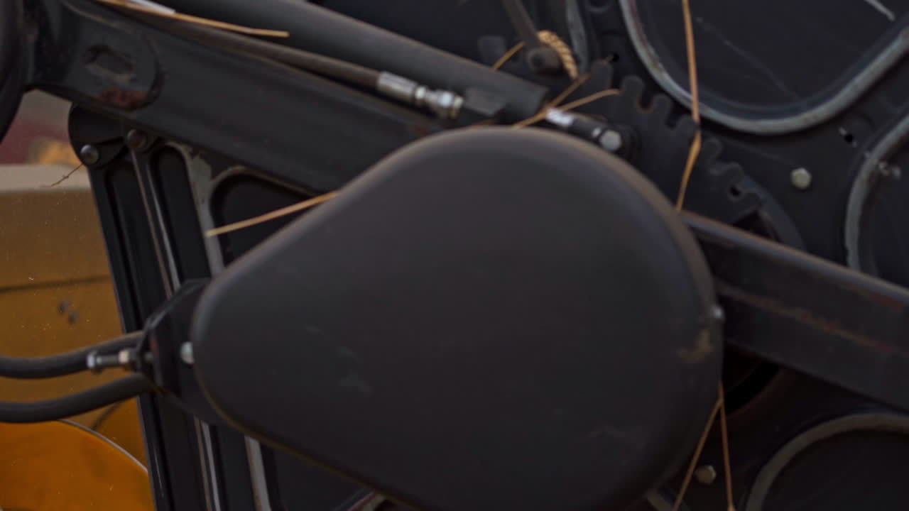 Spinning mechanism of a harvester cuts the ripe spikelets. Close up knife of combine rotating and mowing yellow ears of wheat.