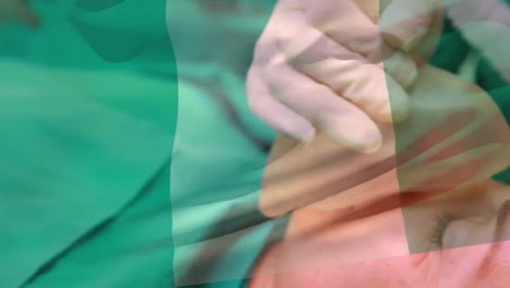 animación de la bandera de nigeria ondeando sobre los cirujanos en el quirófano
