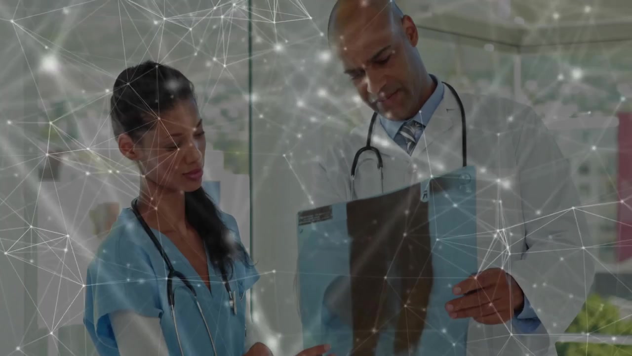 Doctor and Nurse Examining X-ray in Hospital with Digital Network Overlay