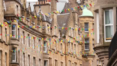 colorful flags adorn historic edinburgh buildings