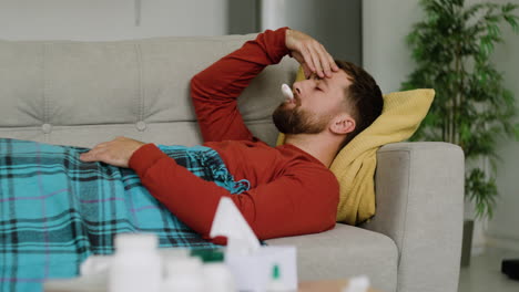 sick man laying on the sofa