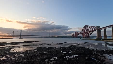 sunset view of bridges and beach in edinburgh