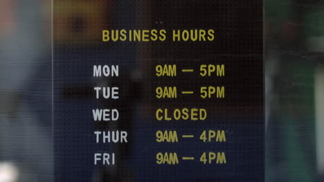 business opening hours in an office shop window