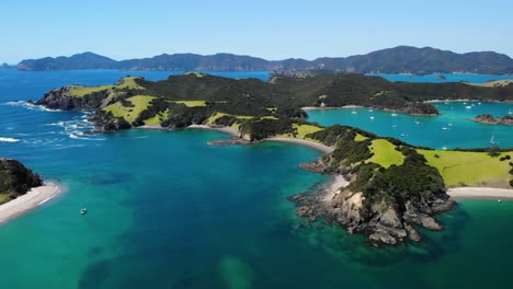 picturesque landscape of urupukapuka island with boats anchored on blue ocean in new zealand