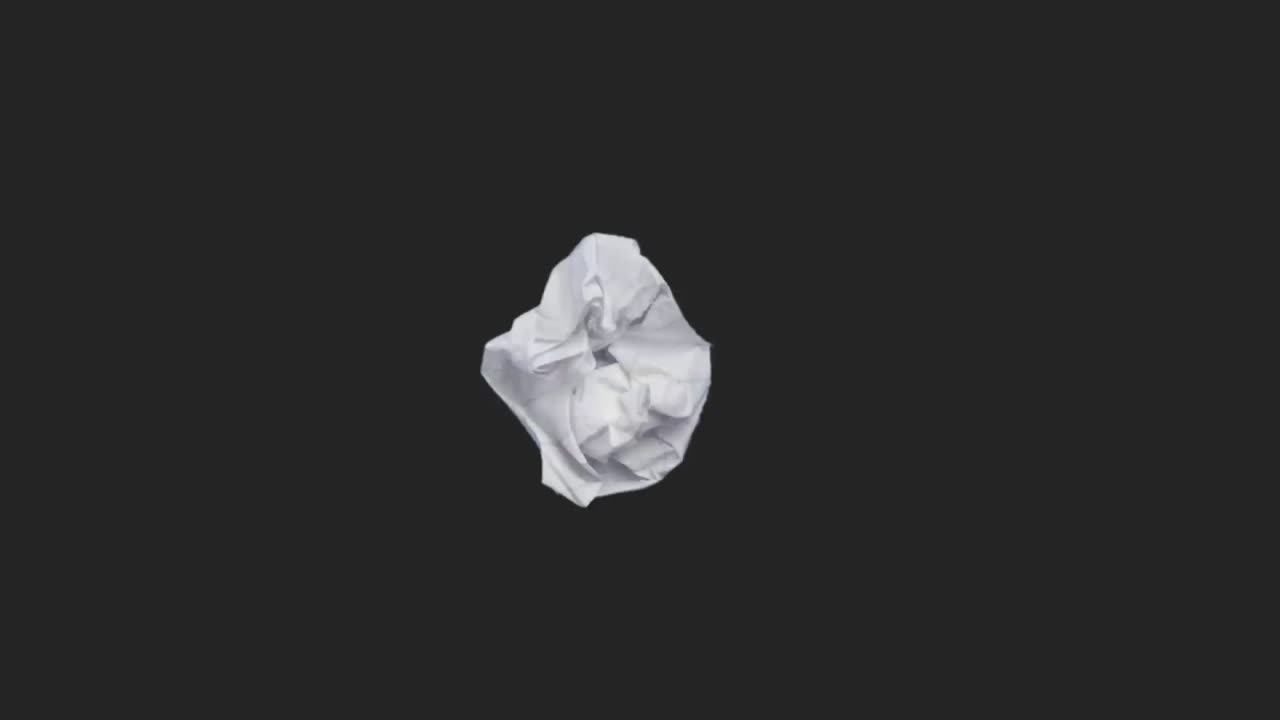 A piece of torn note paper is crushed into a ball