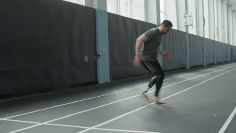 athlete with prosthetic leg doing agility exercise