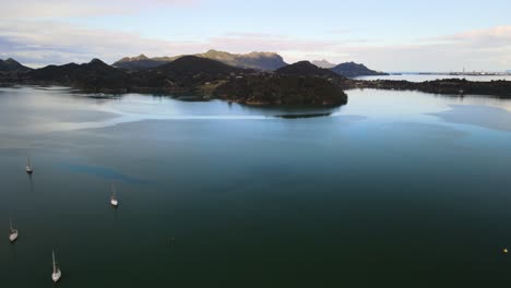 Cinematic-flight-over-Parua-bay-marina-with-sail-boats-berthed-below