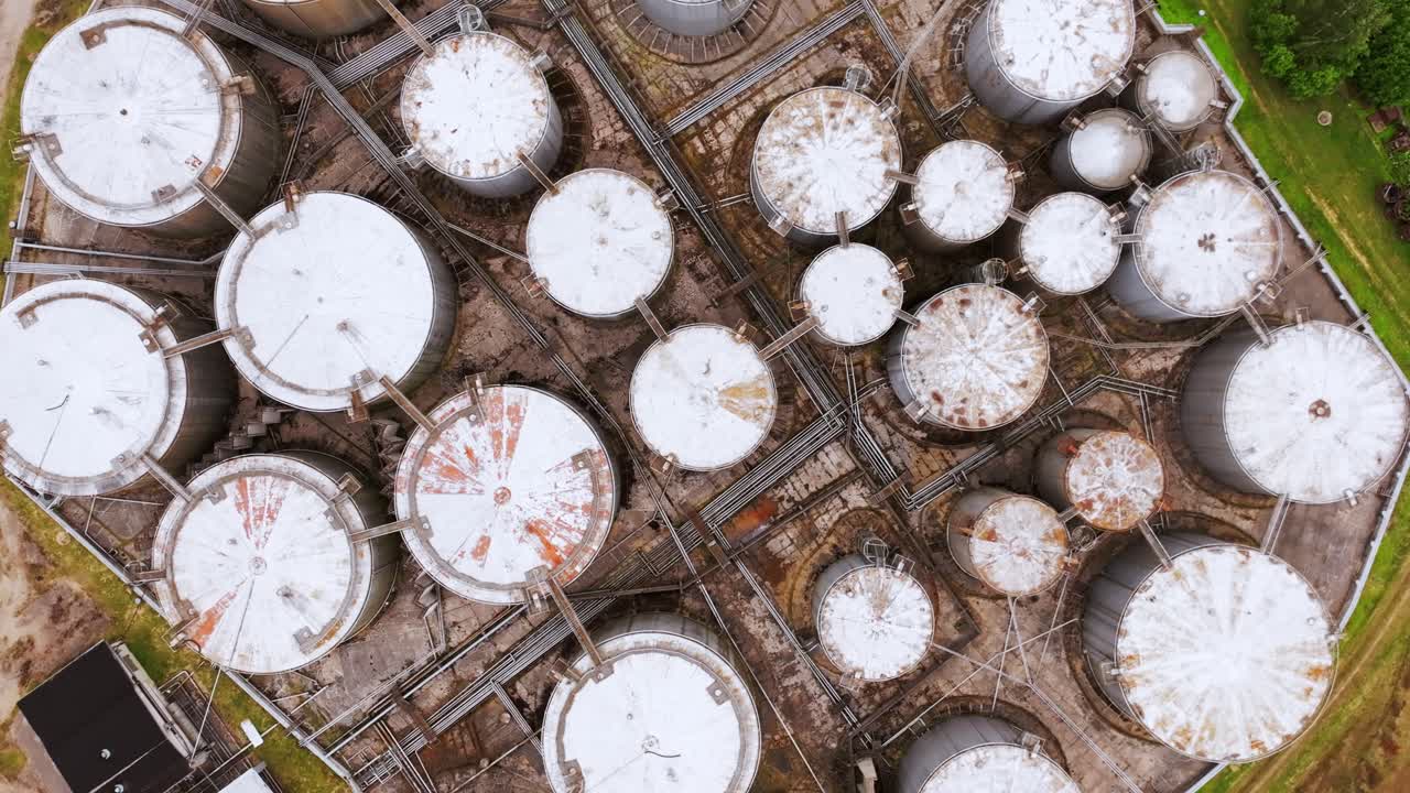 Drone smoothly lowers altitude and closes in on one industrial storage container