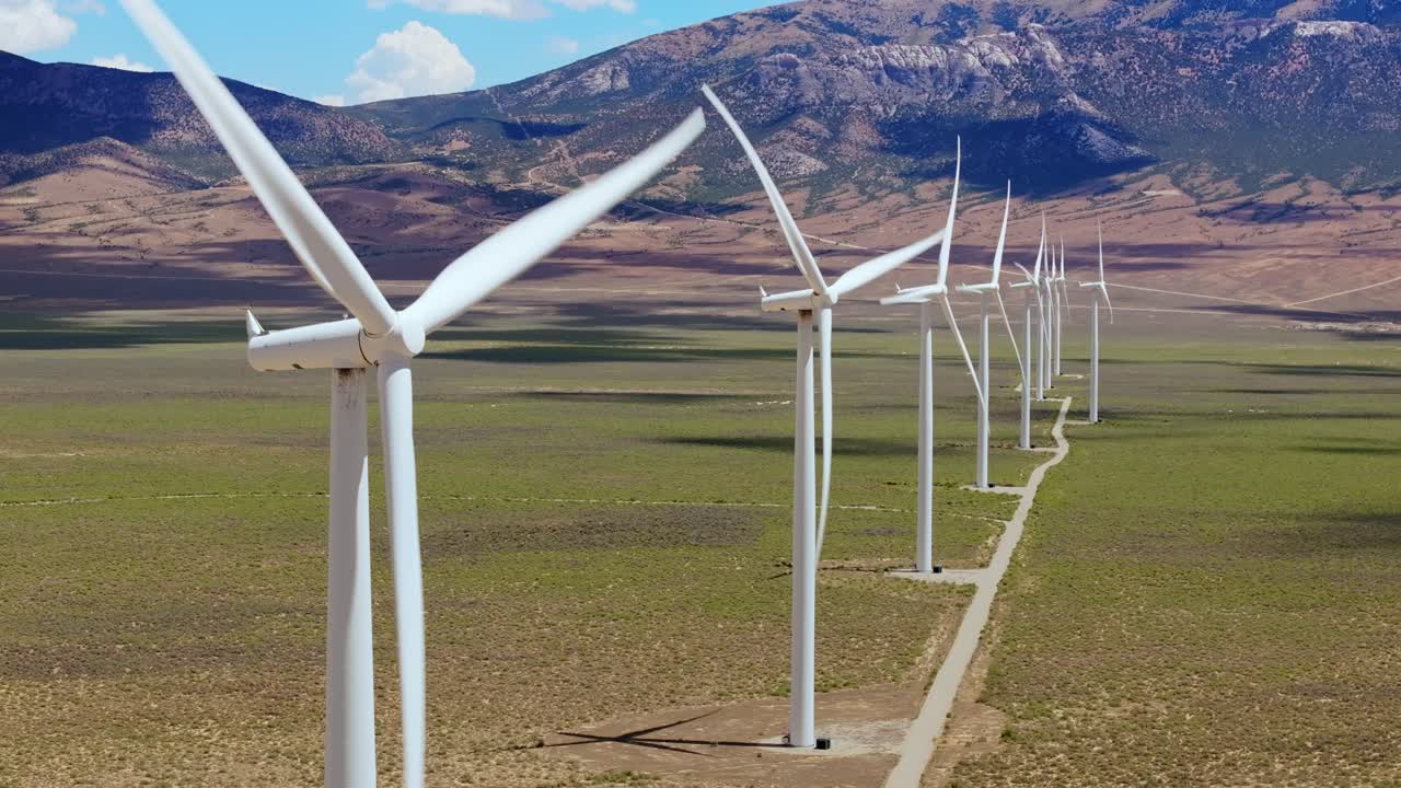 Wind turbines in Nevada desert stretching to distant mountains