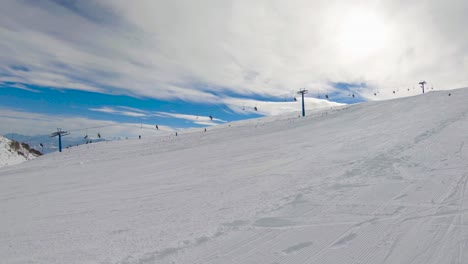 surface ski lift and skiers on a ski resort