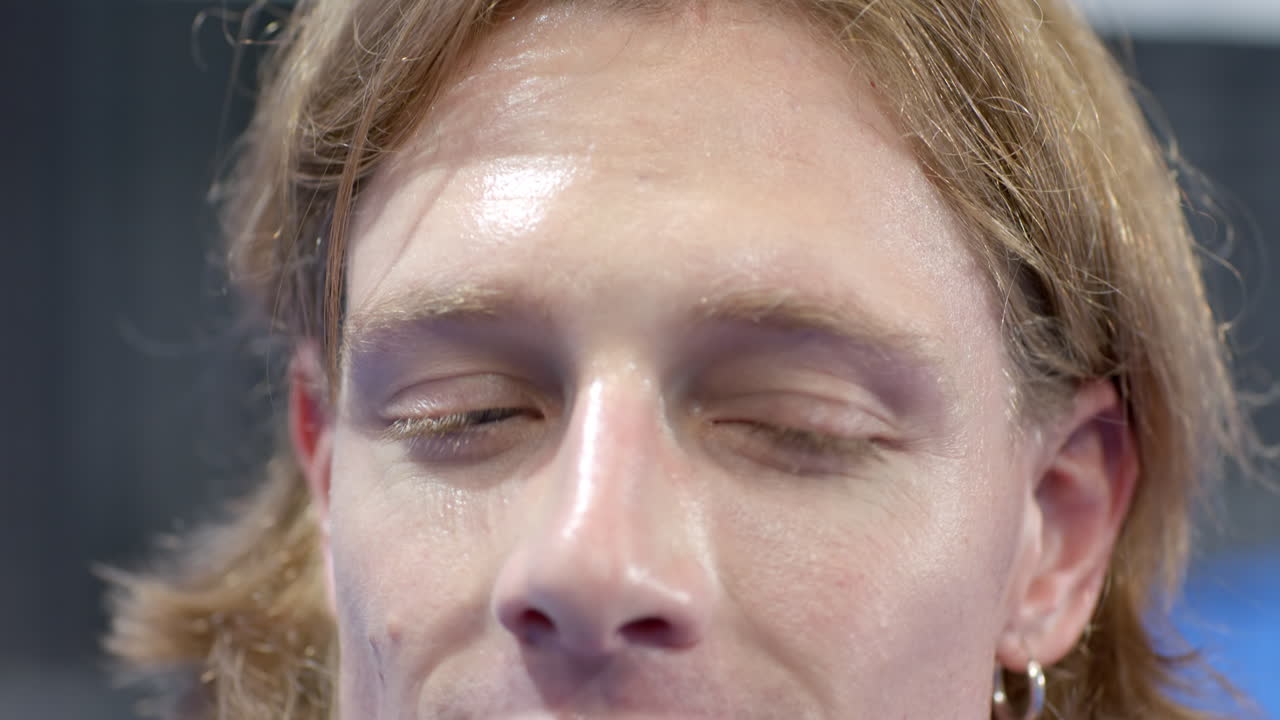 Focused young man concentrating intensely, preparing for padel tennis match, at indoor court