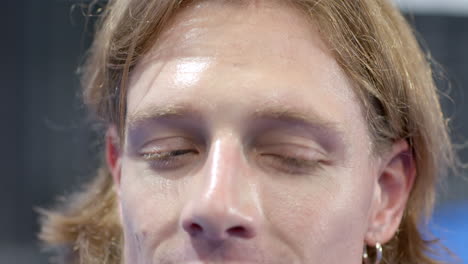 focused young man concentrating intensely, preparing for padel tennis match, at indoor court