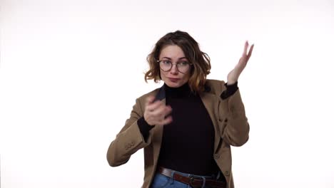 Portrait-of-girl-with-curly-hair-in-stylish-glasses,-she-dancing-comically-with-delight.-Surprised-excited-happy-woman-makes-funky-style-dancing.-European-female-model-in-casual-on-white-background