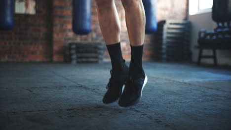 Gym,-feet-and-man-jumping-with-rope-for-leg-muscle