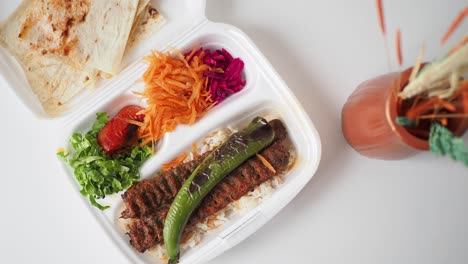 turkish kebab meal in a disposable container