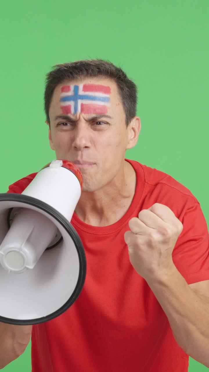 Excited man with norwegian flag on face using a megaphone