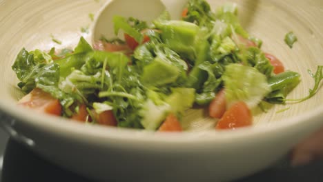 Fresh-healthy-salad-is-stirred-in-a-large-cup