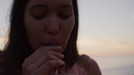 Young-woman-drinking-a-smoothie