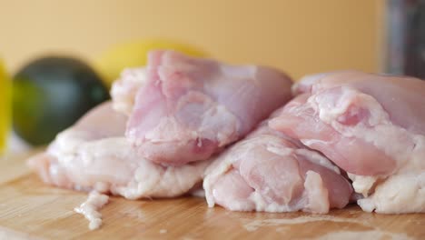 raw chicken thighs on a cutting board