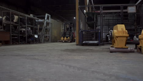 industrial warehouse interior at night with forklift