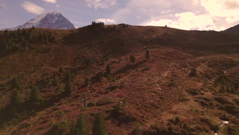 aerial drone footage pushing in over alpine scenery in fall colors in swiss alps