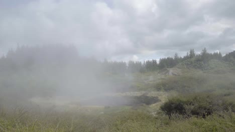 a wide shot of thermal activity coming from a crater at craters of the moon in taupo, nz