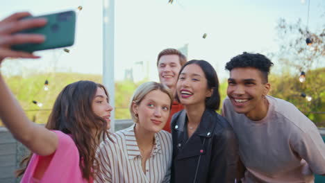 smiling students taking selfie photo at terrace closeup. happy people having fun