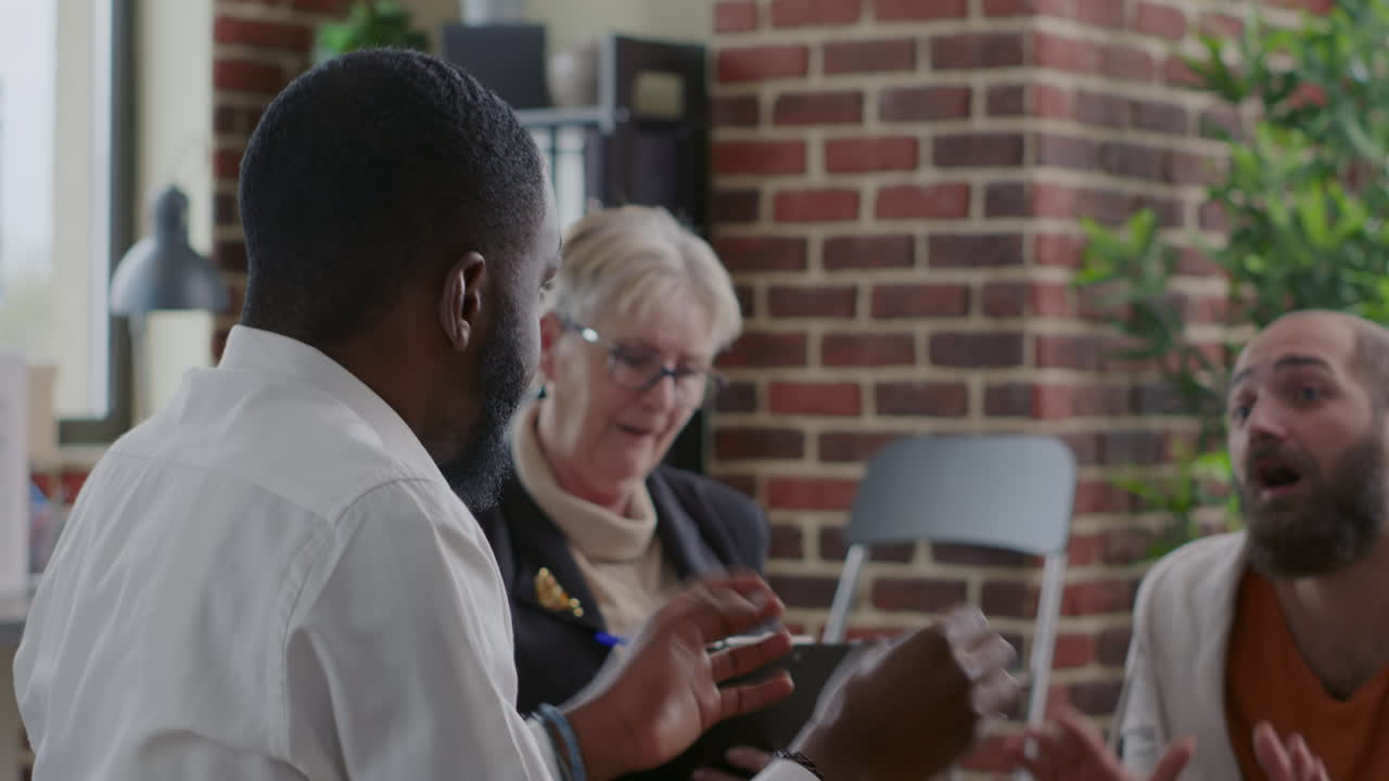 African american man complaining about alcohol addiction and recovery at aa group meeting