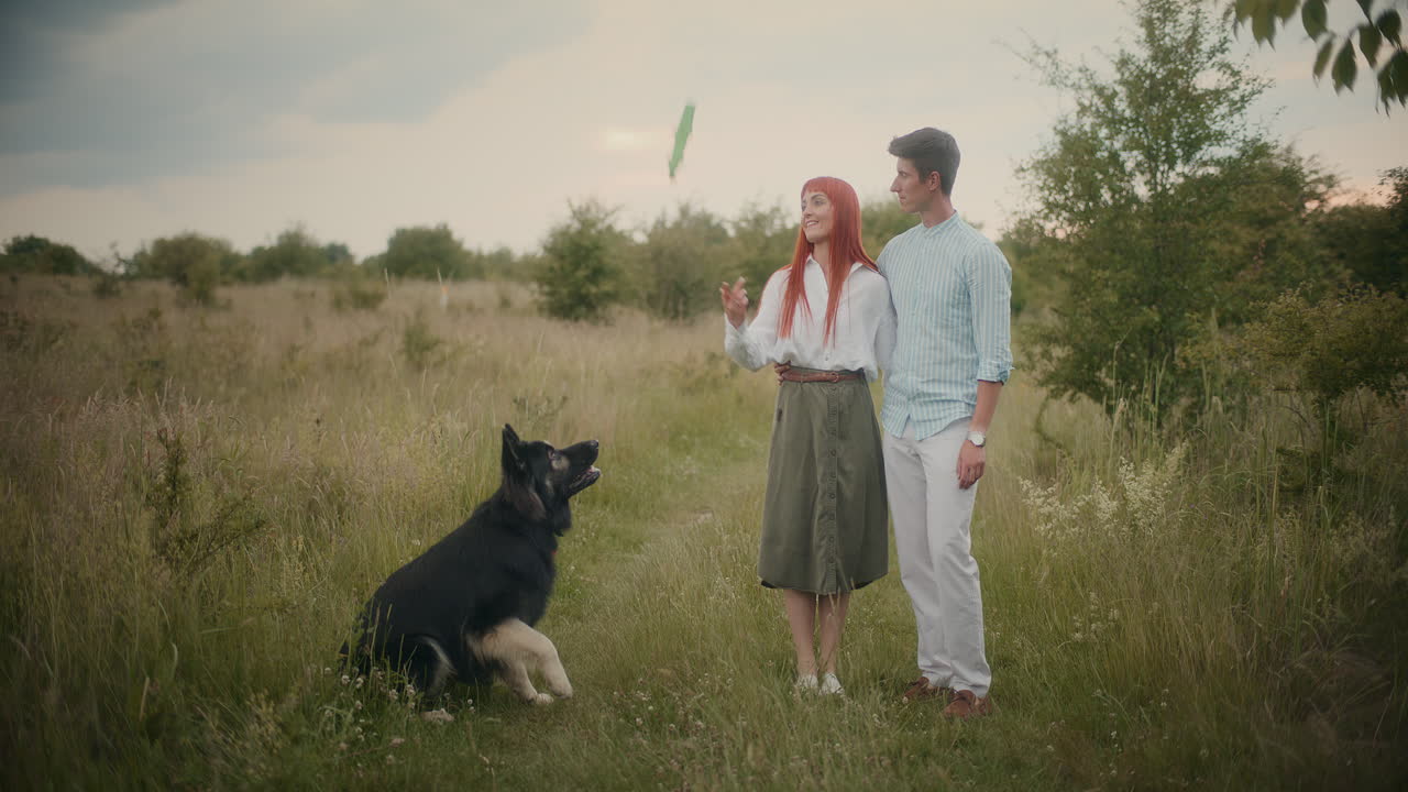 Couple with dog in a field