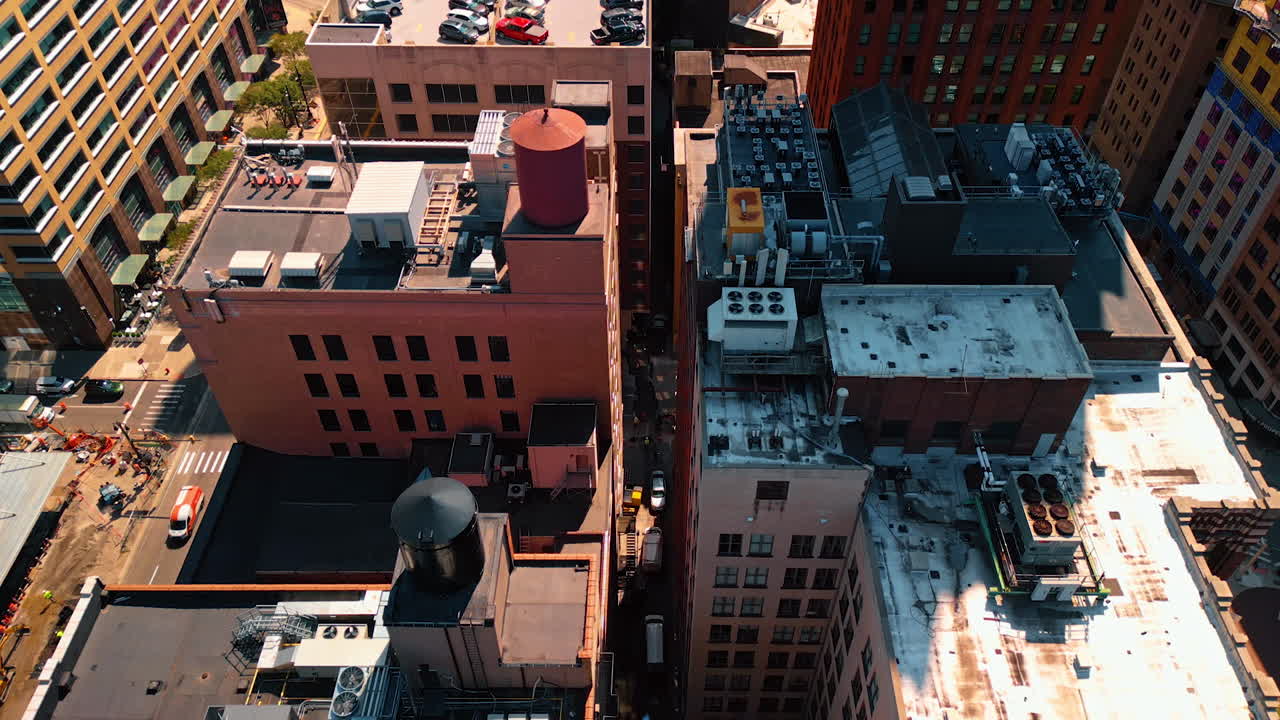 Ventilation equipment, water tanks and parking lot on the rooftops of the high-rise buildings. Drone flight over the tops of Detroit, Michigan, USA. Detroit, USA, 28 July 2025: